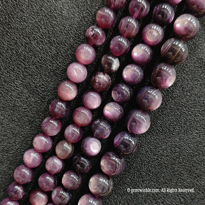 Close up of stabilized purple lepidolite crystal beads highlighting the unique glittering mica sheets from image_11359b.jpg