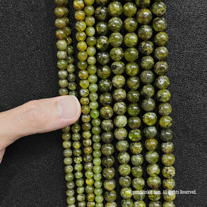 close up look of grade c green peridot beads showing natural earth inclusions