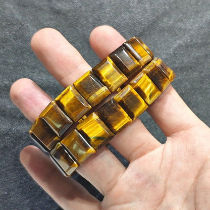 Perspective shot of a stacked golden tiger eye flat bead strand showing two matching pieces on hand