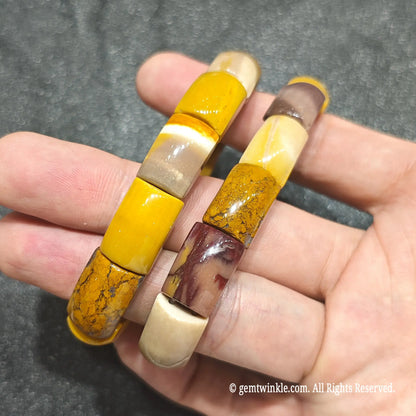 Double strand view of mookaite jasper barrel stretch bracelets showing natural color variations under ambient light