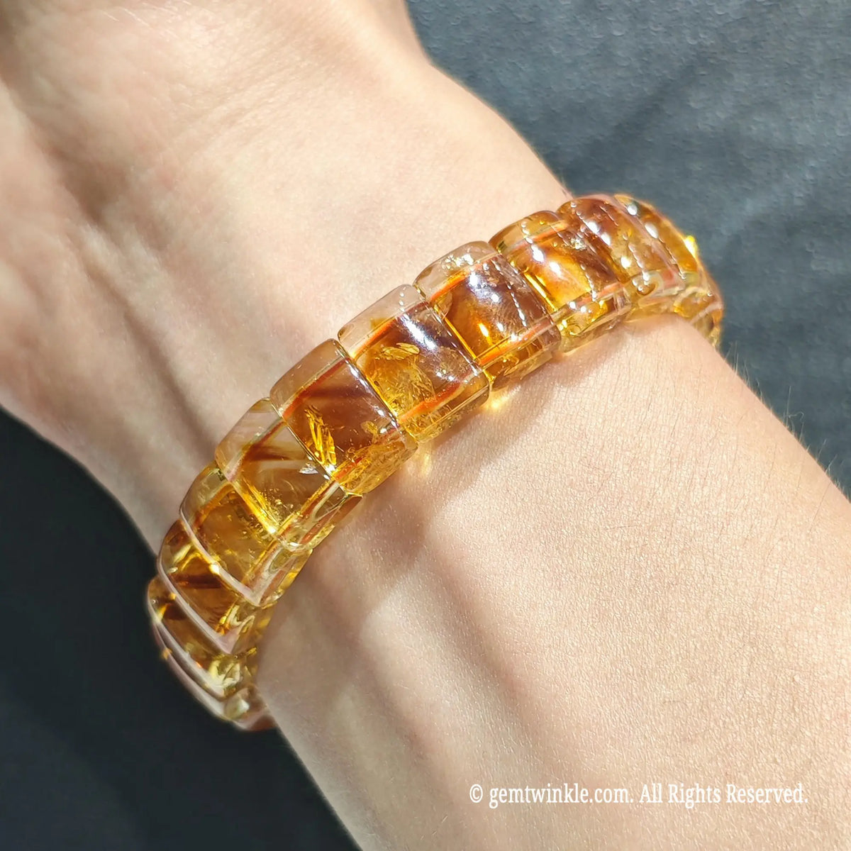 Full view of a stacked unisex citrine quartz wristband worn on wrist under bright daylight