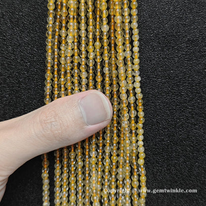 Bulk wholesale strands of 3mm small round gold rutilated quartz loose beads perfect for fine jewelry making and delicate stacking bracelets