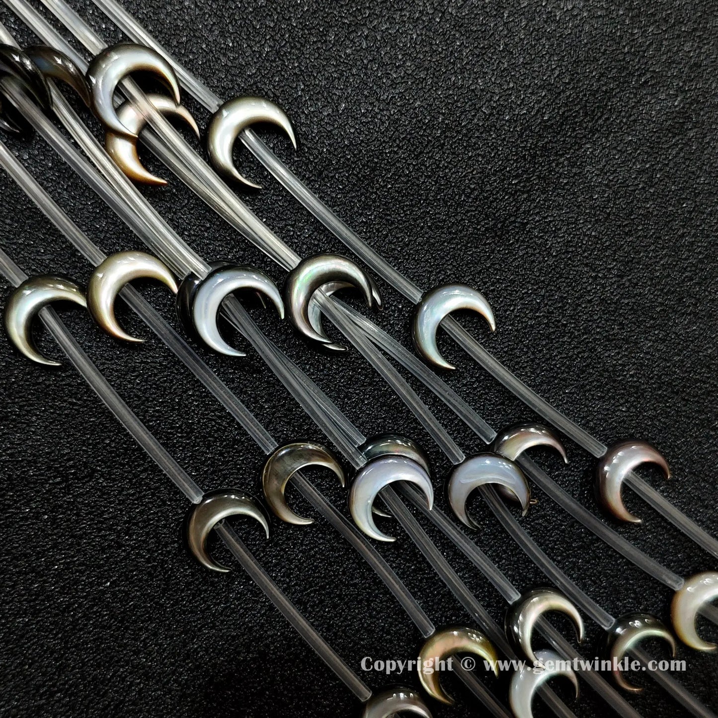 Multiple strands of black mop crescent moon beads with iridescent sheen