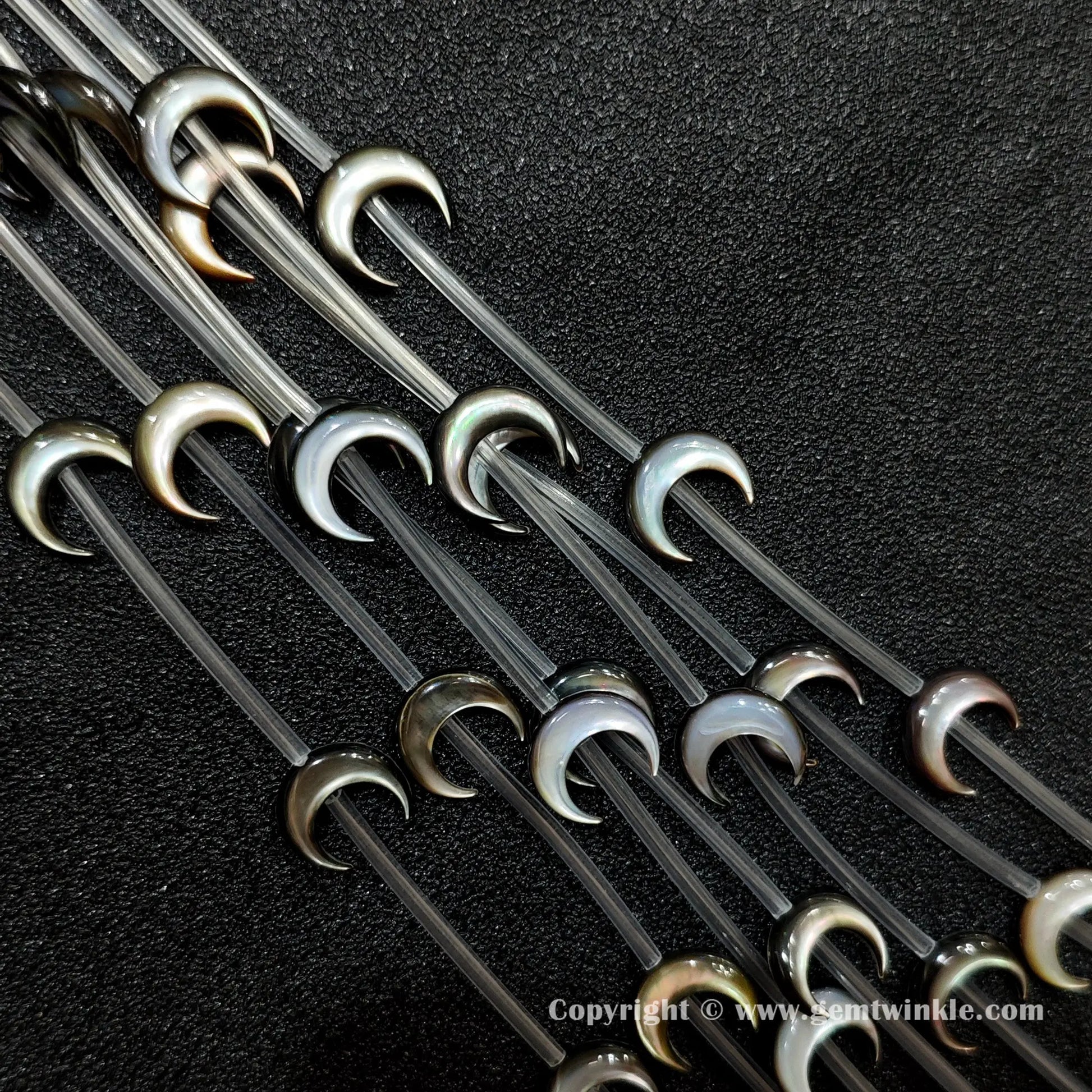 Multiple strands of black mop crescent moon beads with iridescent sheen