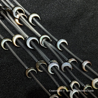 Multiple strands of black mop crescent moon beads with iridescent sheen