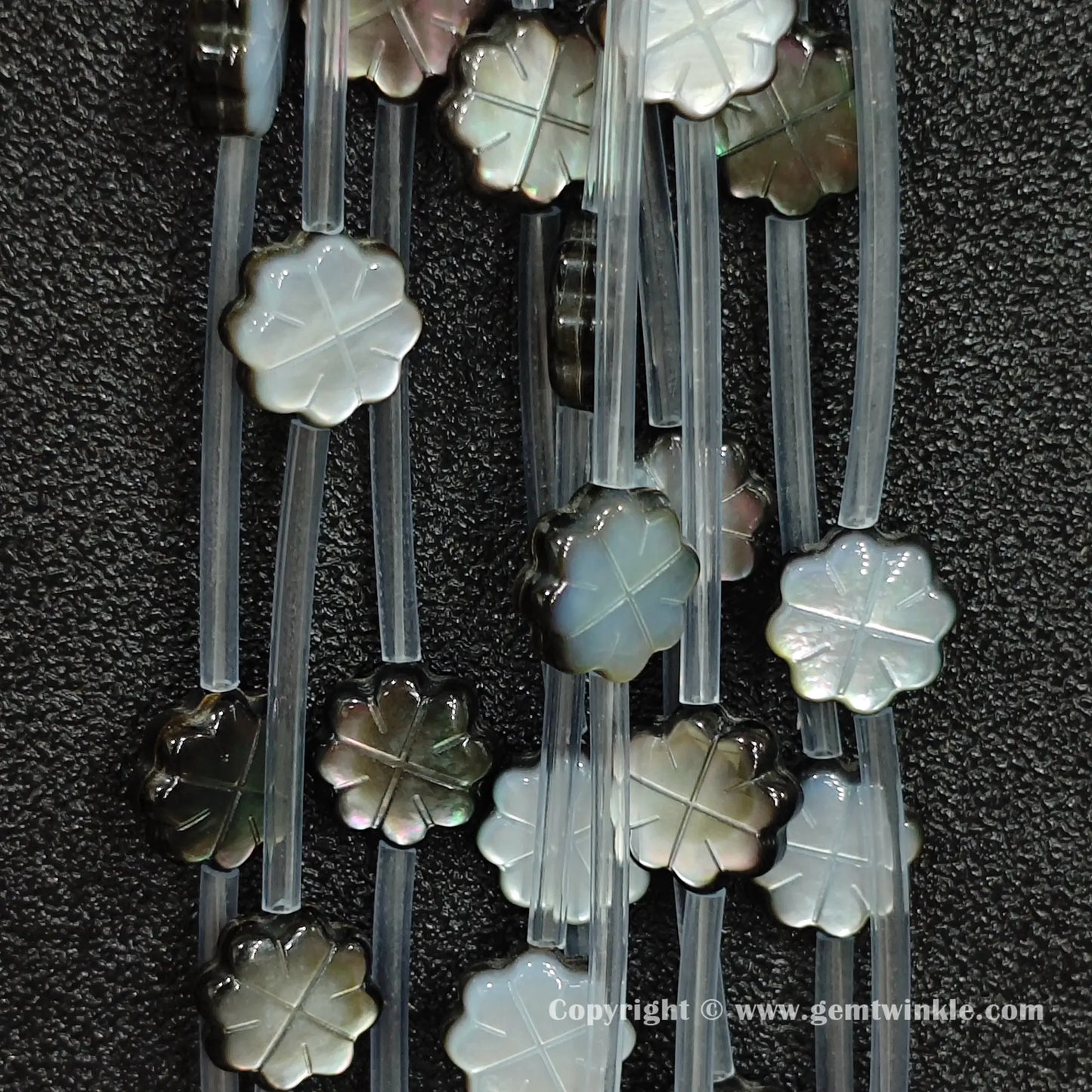 Multiple strands of dark mop plum blossom beads with peacock iridescence