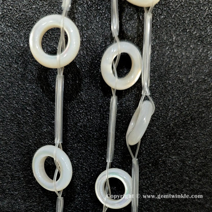 Handheld preview showing 14mm double sided laminated white shell ring beads