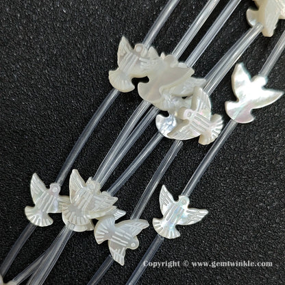 Multiple strands of white mop dove silhouette beads with pearly luster