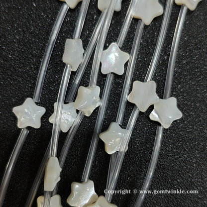 Multiple strands of white mop smiling star beads with pearlescent luster