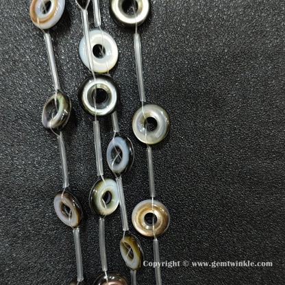 strands of layered black shell donut beads with rainbow luster