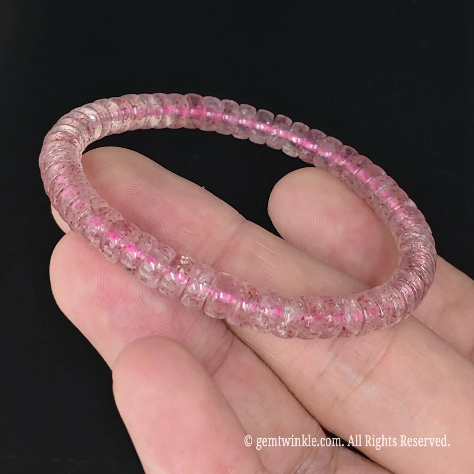 fingers pinching 5.5-6mm pink strawberry quartz wheel bead stretch bangle