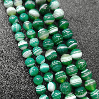 Four strands of vibrant green striped agate loose crystal beads highlighting high polish spherical finish direct from donghai market