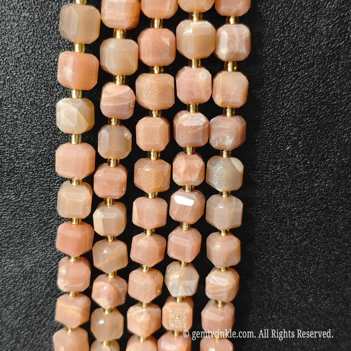 Macro close-up showing the peach-orange body and reflective copper inclusions of sunstone blocks