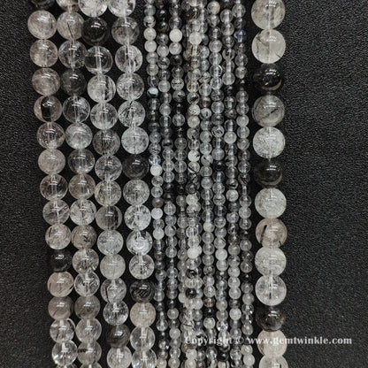 Bulk display of un-dyed commercial B grade black tourmaline rutilated quartz bead strands perfect for handmade bracelet and necklace designs