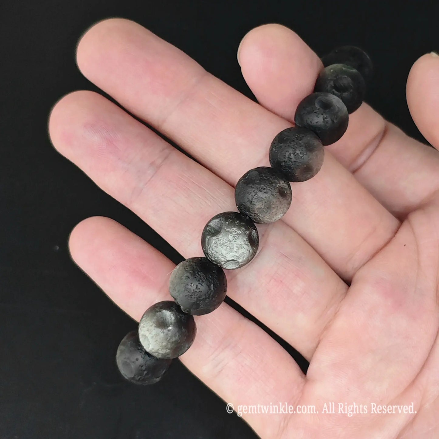 Matte Crater Silver Obsidian Round Bead Bracelet Held Flat
