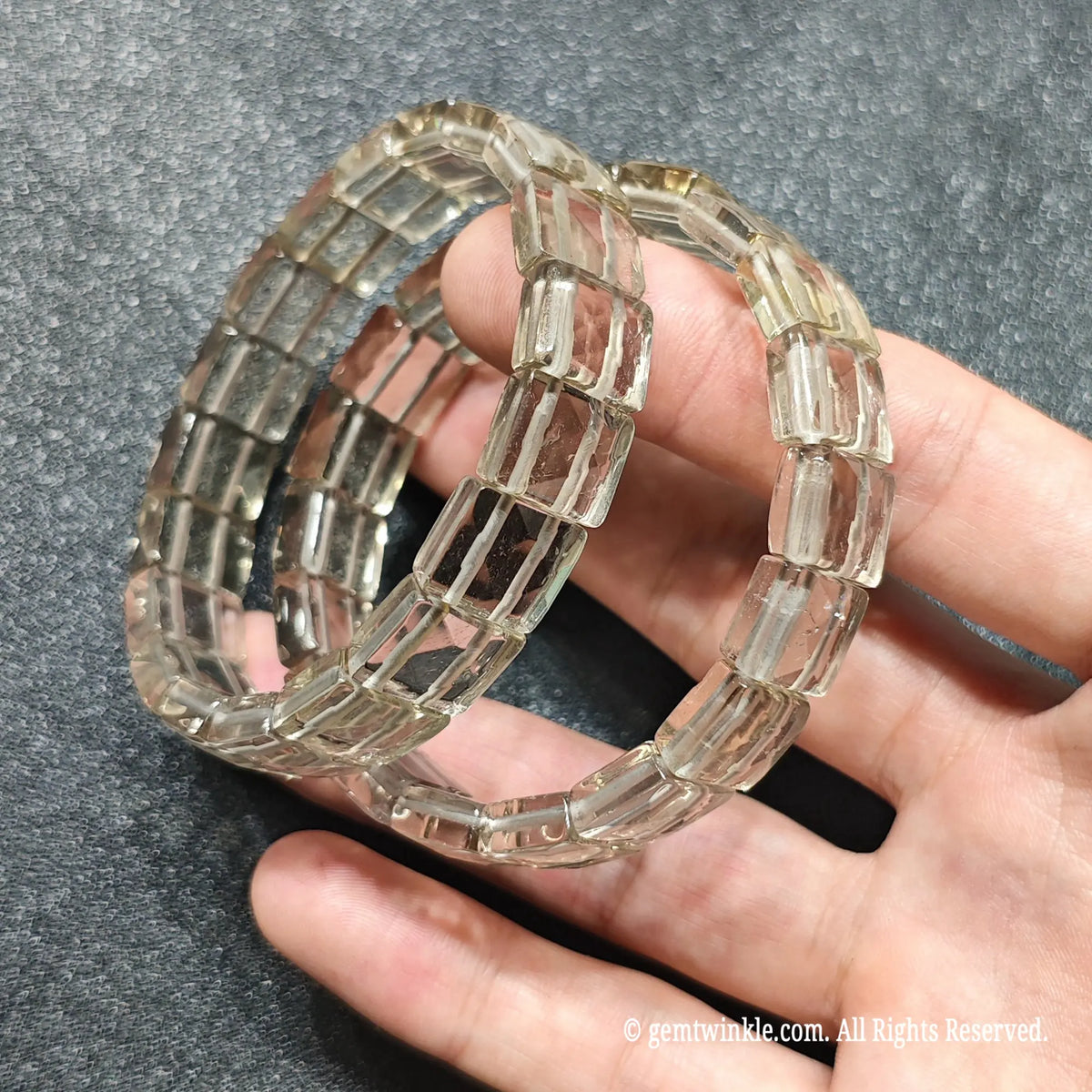Full view of a thoughtful gift smoky quartz gemstone band held in hand showing subtle champagne tones