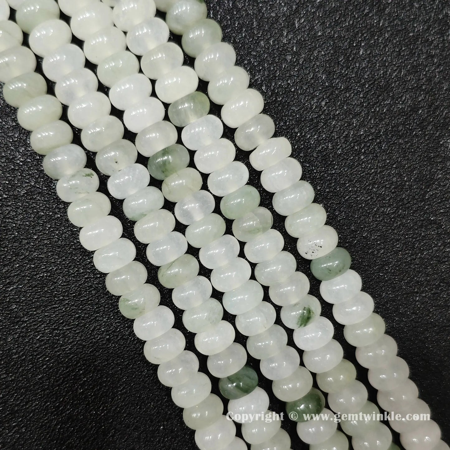 Perspective view of tianshan jade smooth heishi spacer beads showing uniform 4mm disc thickness