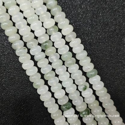 Perspective view of tianshan jade smooth heishi spacer beads showing uniform 4mm disc thickness