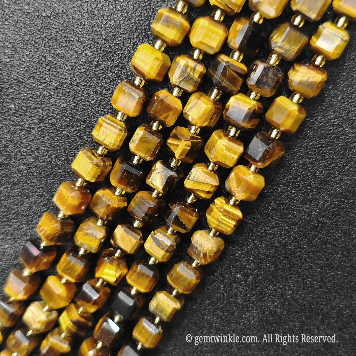 Macro close-up showing the golden brown optical shimmer and fibrous details of tiger eye blocks