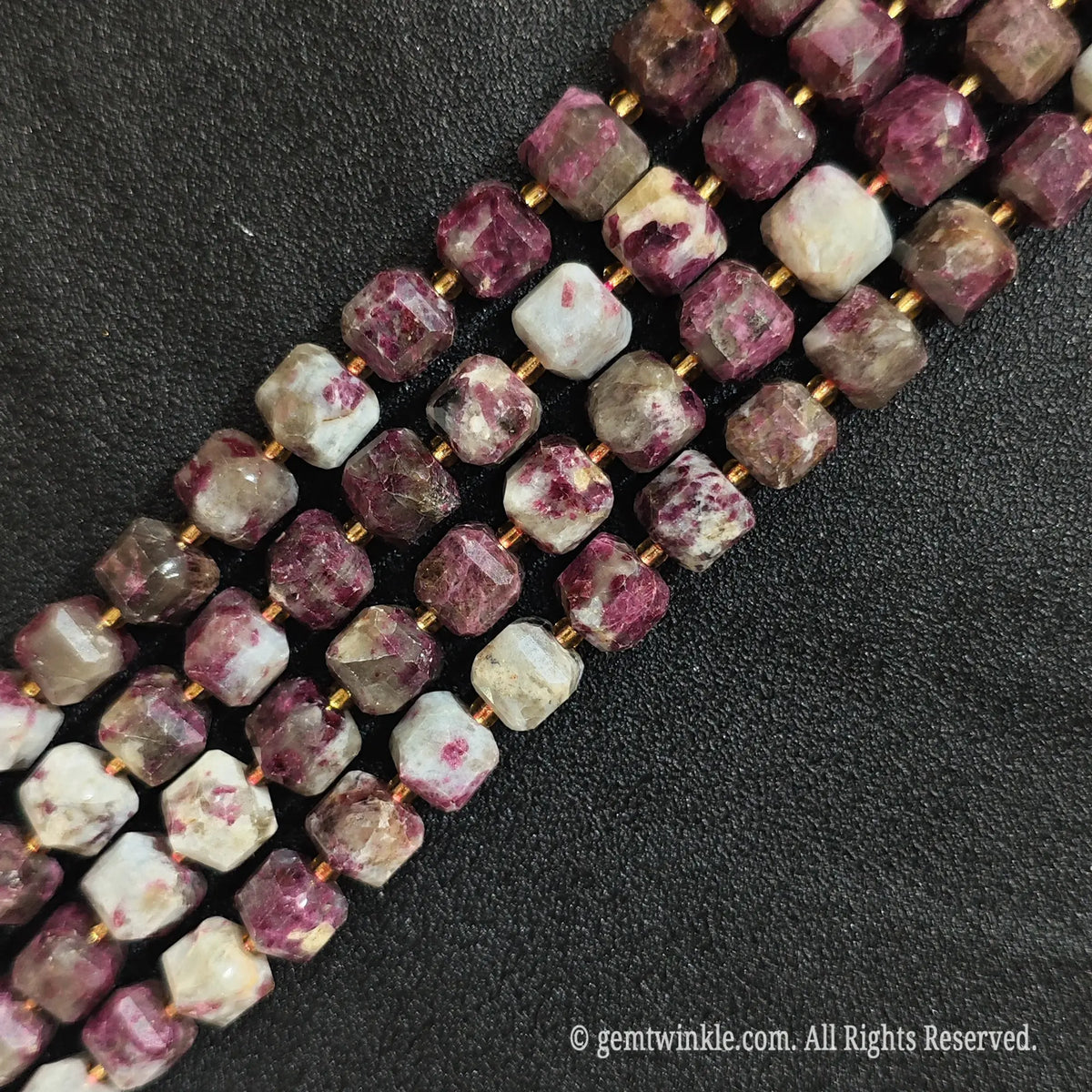 Macro close-up showing the magenta pink and milky white structural details of tourmaline blocks
