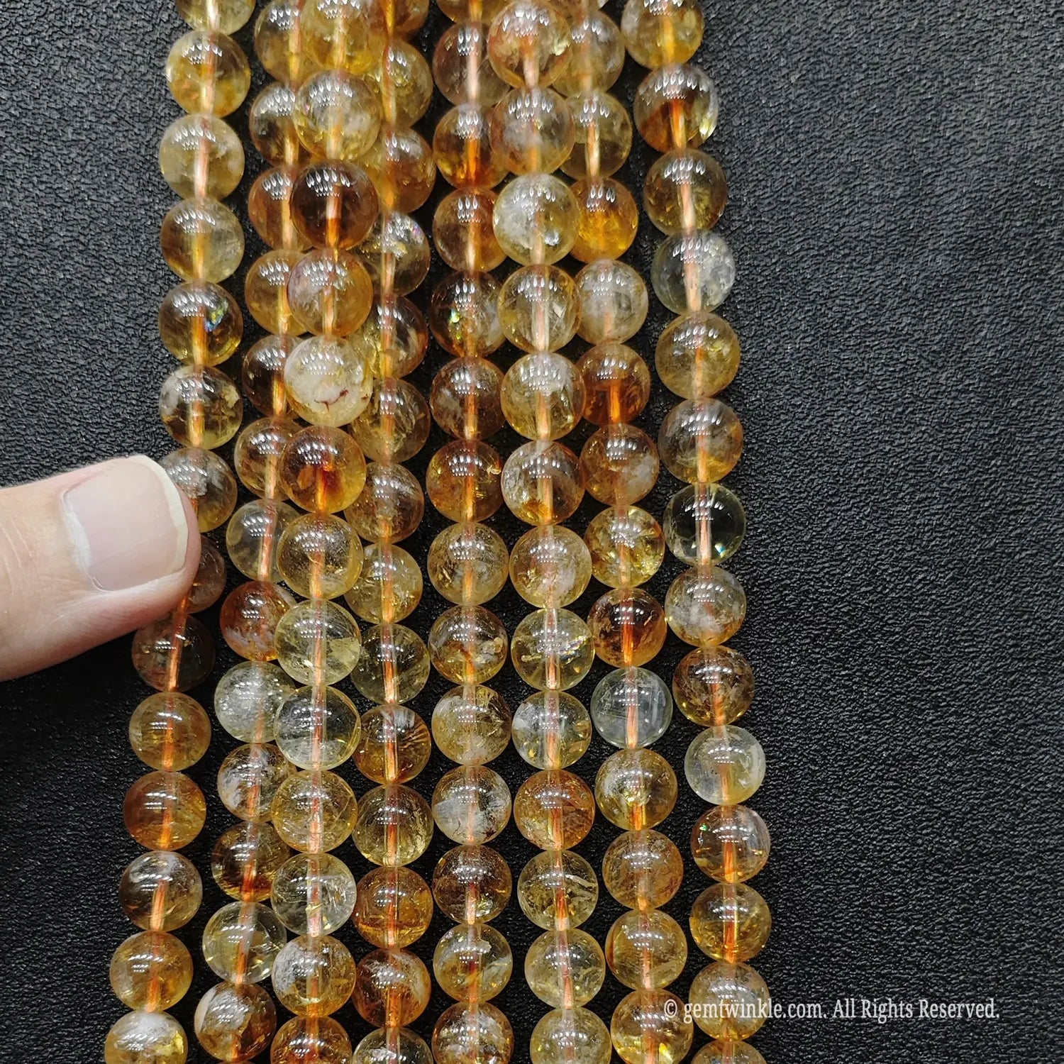 Parallel vertical alignment of premium translucent golden tower quartz crystal strands indicating superior light refraction