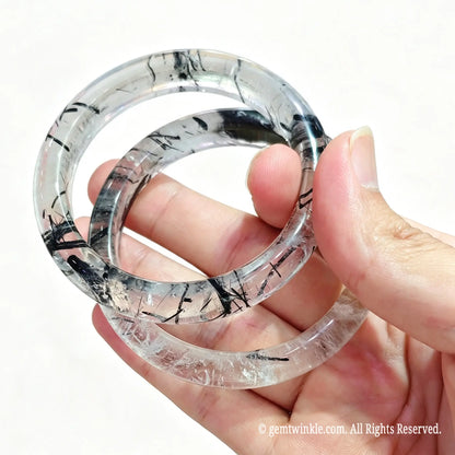 Translucent black hair quartz bangles displayed for small batch inventory and 1-on-1 video selection