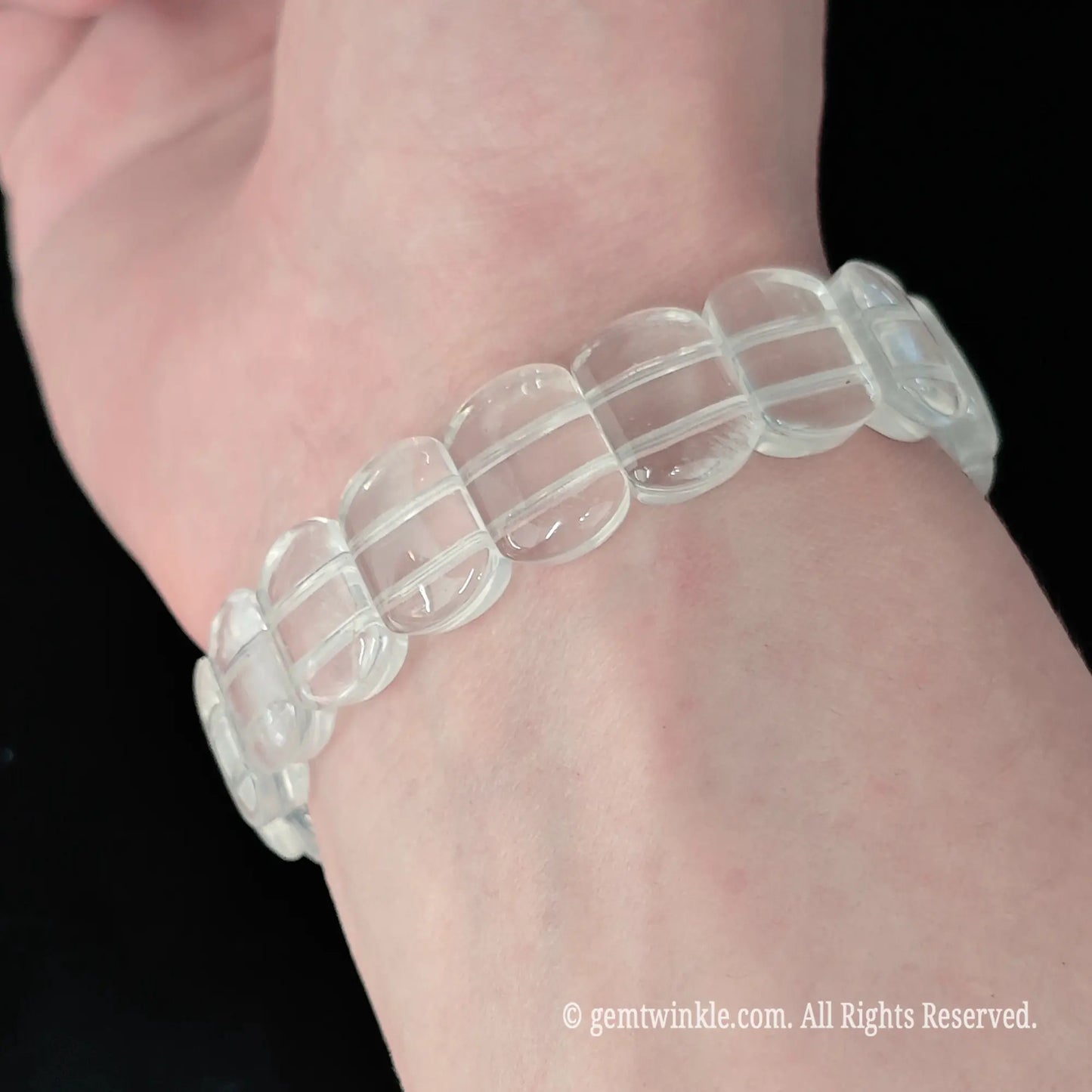 Translucent milky white crystal smooth rectangular bead stretch bracelet styled on wrist displaying soft cloudy finish