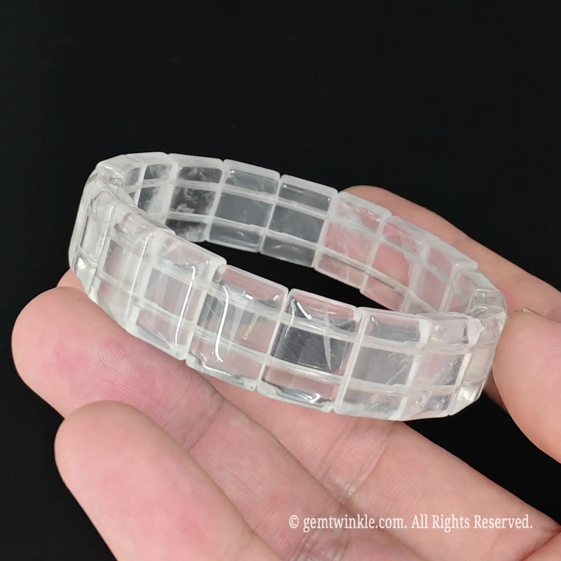 Translucent milky white crystal smooth tile bead stretch bracelet held showing cloudy translucency and smooth edges