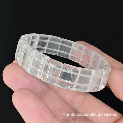 Translucent milky white crystal smooth tile bead stretch bracelet held showing cloudy translucency and smooth edges