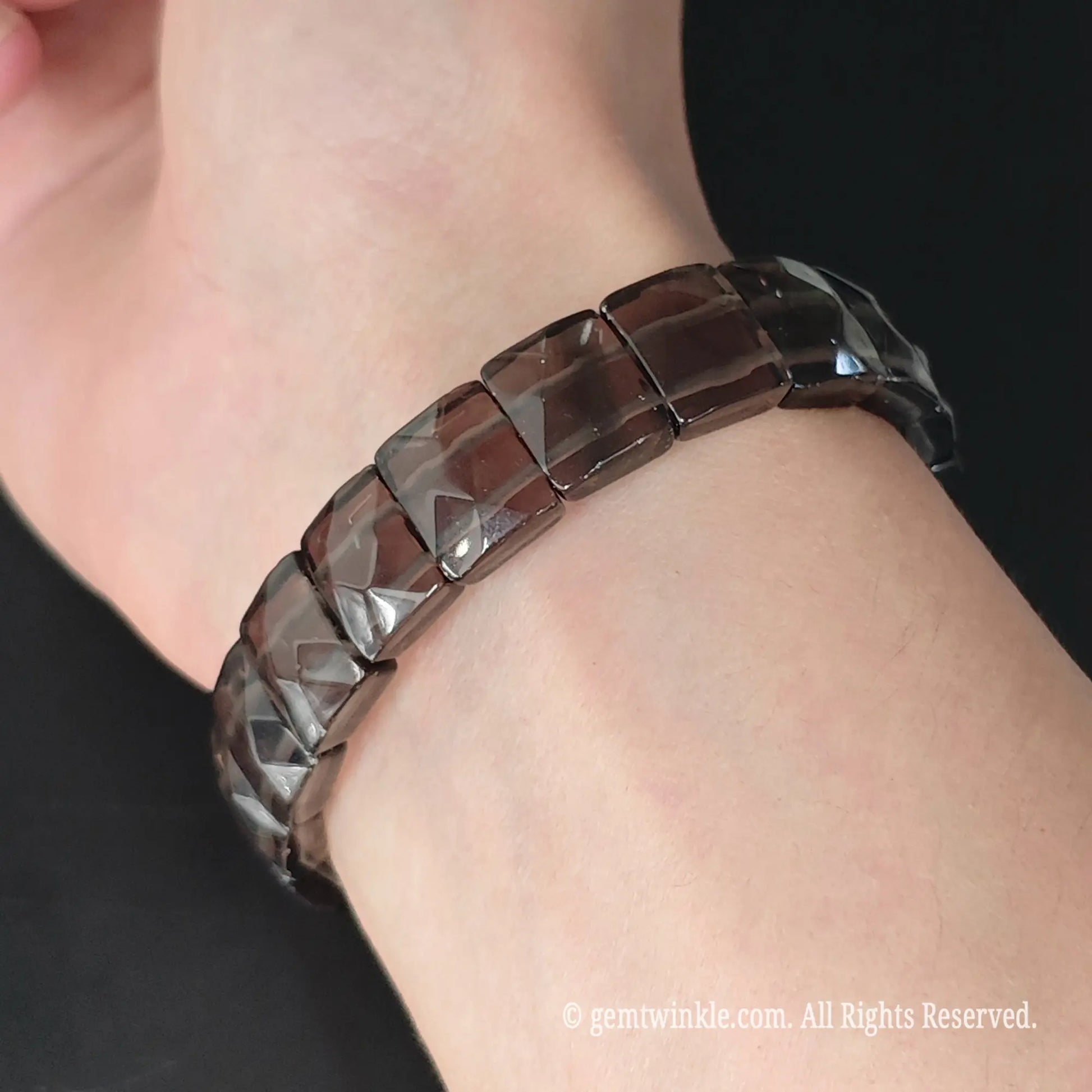 Translucent obsidian 11mm square bead pyramid faceted stretch bracelet styled on wrist showcasing geometric profile