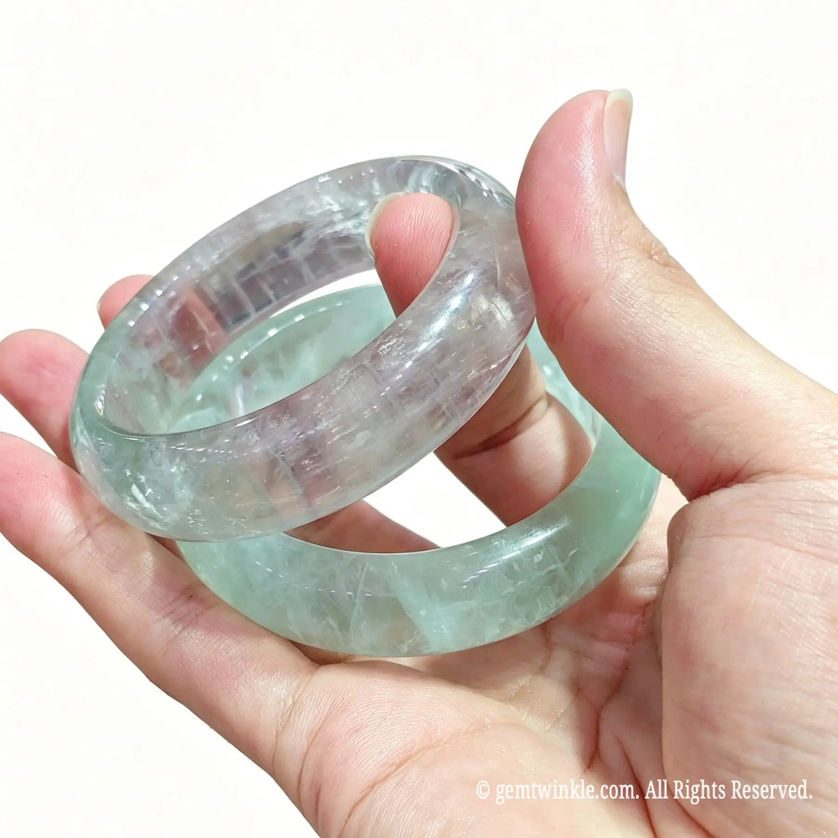 Close up view of mint green fluorite carved wristband showing natural mineral zoning and soft pastel clarity