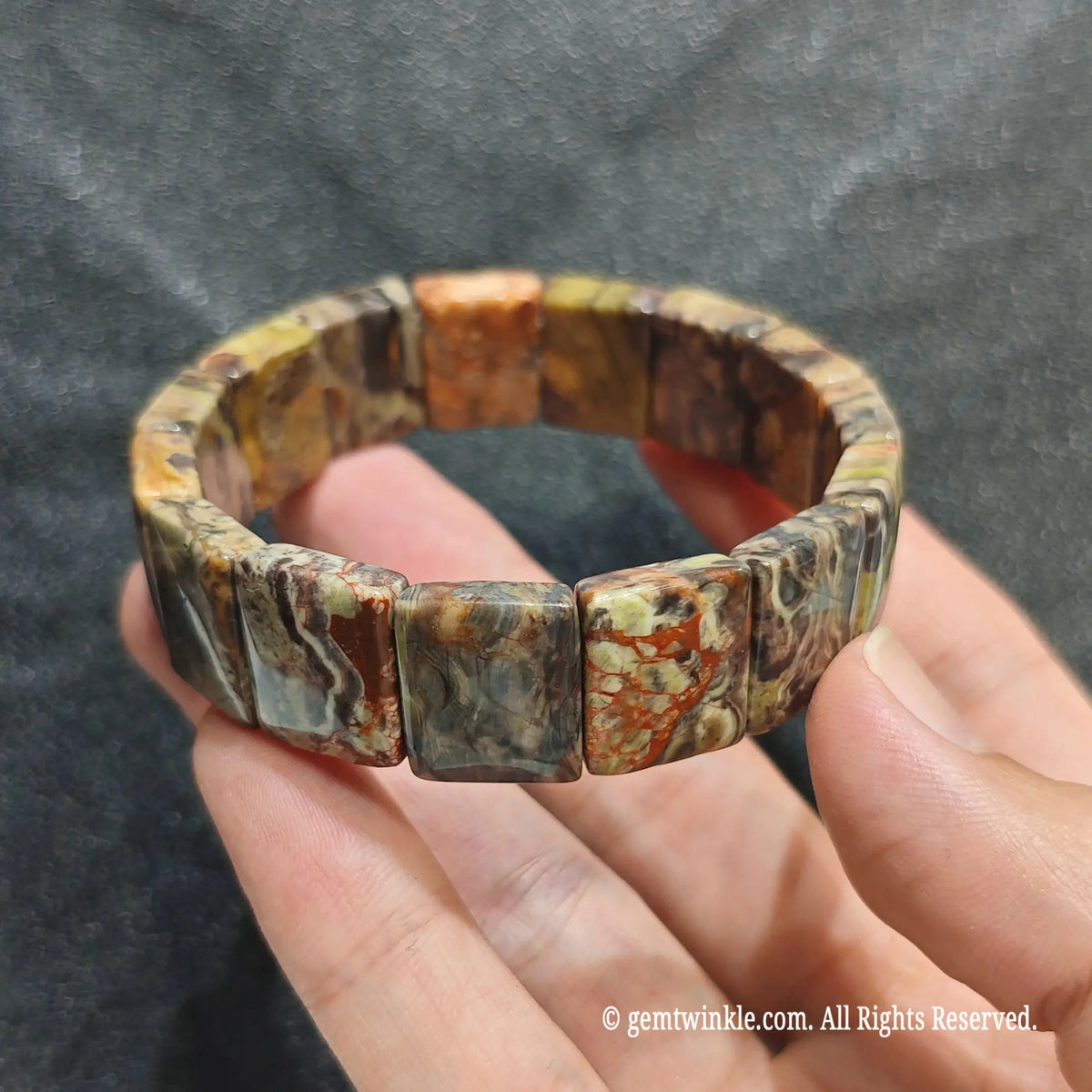 Perspective shot of a tribal boho crazy lace agate flat bead strand highlighting multi-colored quartz layers