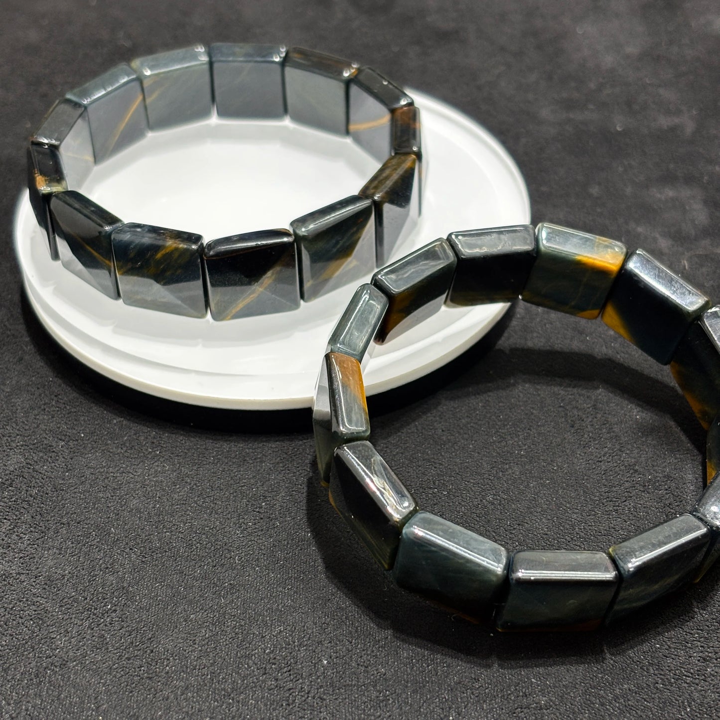 Two Natural Blue & Yellow Tiger Eye Faceted Rectangle Bangle Bracelets on White Plate