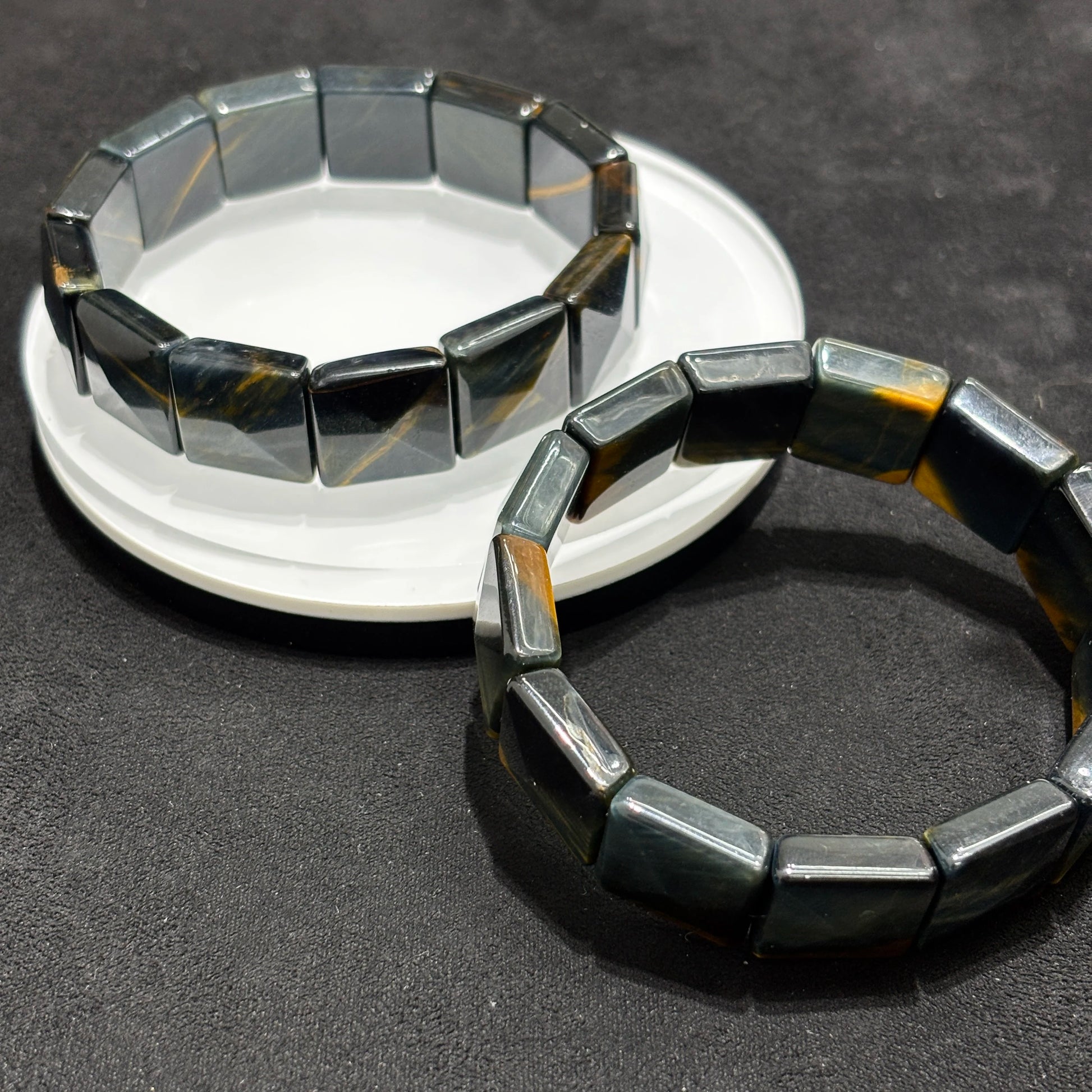 Two Natural Blue & Yellow Tiger Eye Faceted Rectangle Bangle Bracelets on White Plate