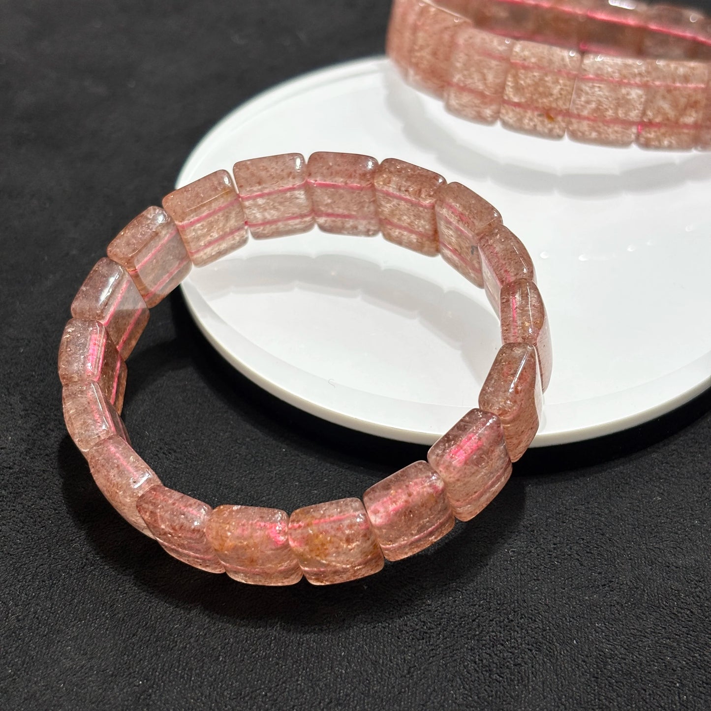 Two Natural Strawberry Quartz Bangle Bracelets on White Plate