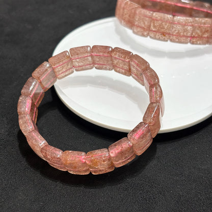 Two Natural Strawberry Quartz Bangle Bracelets on White Plate
