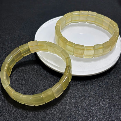 Two Natural Yellow Fluorite Bangle Bracelets stacked on a white plate, demonstrating the stackable design and uniform sizing.