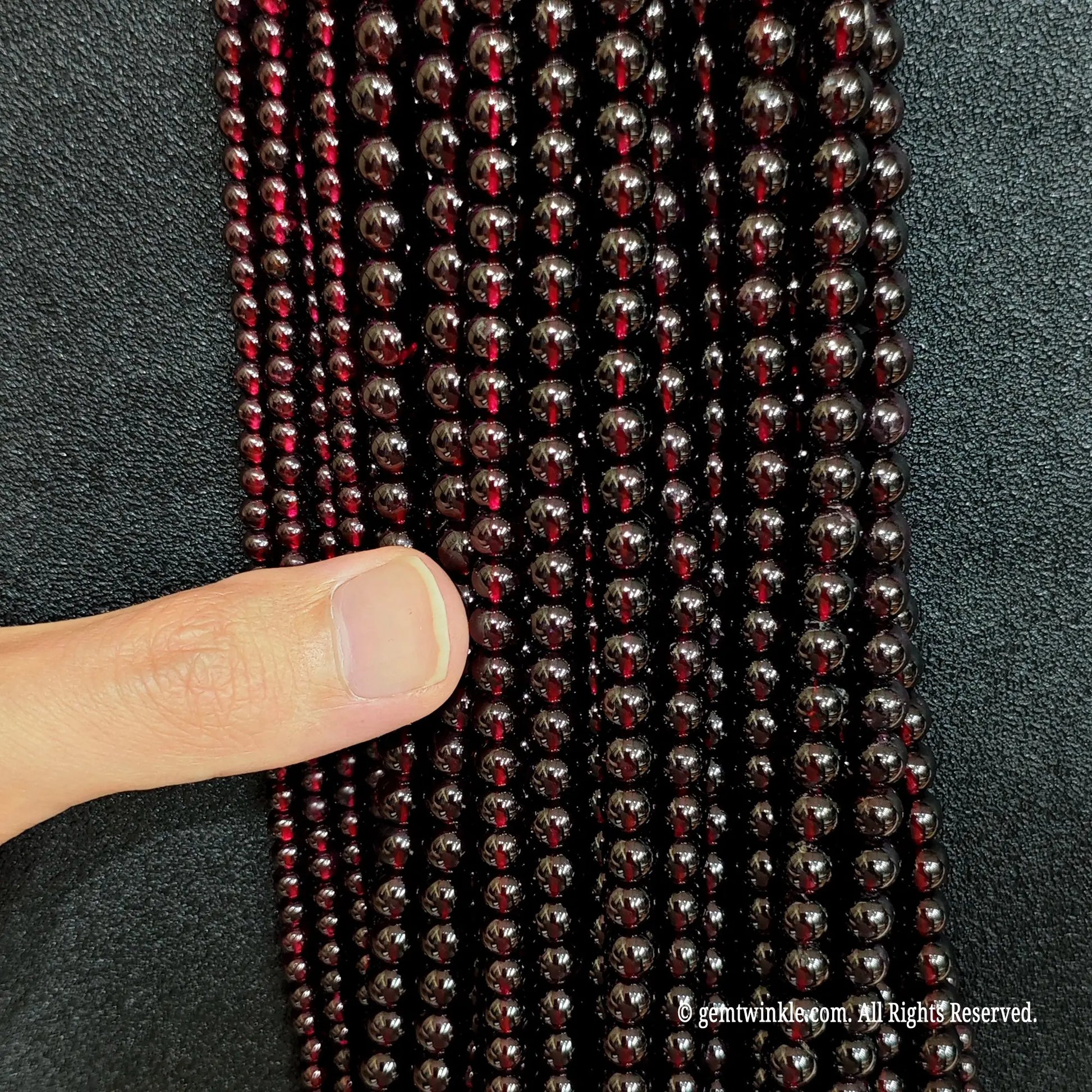 detailed macro shot of authentic deep red garnet gemstone beads