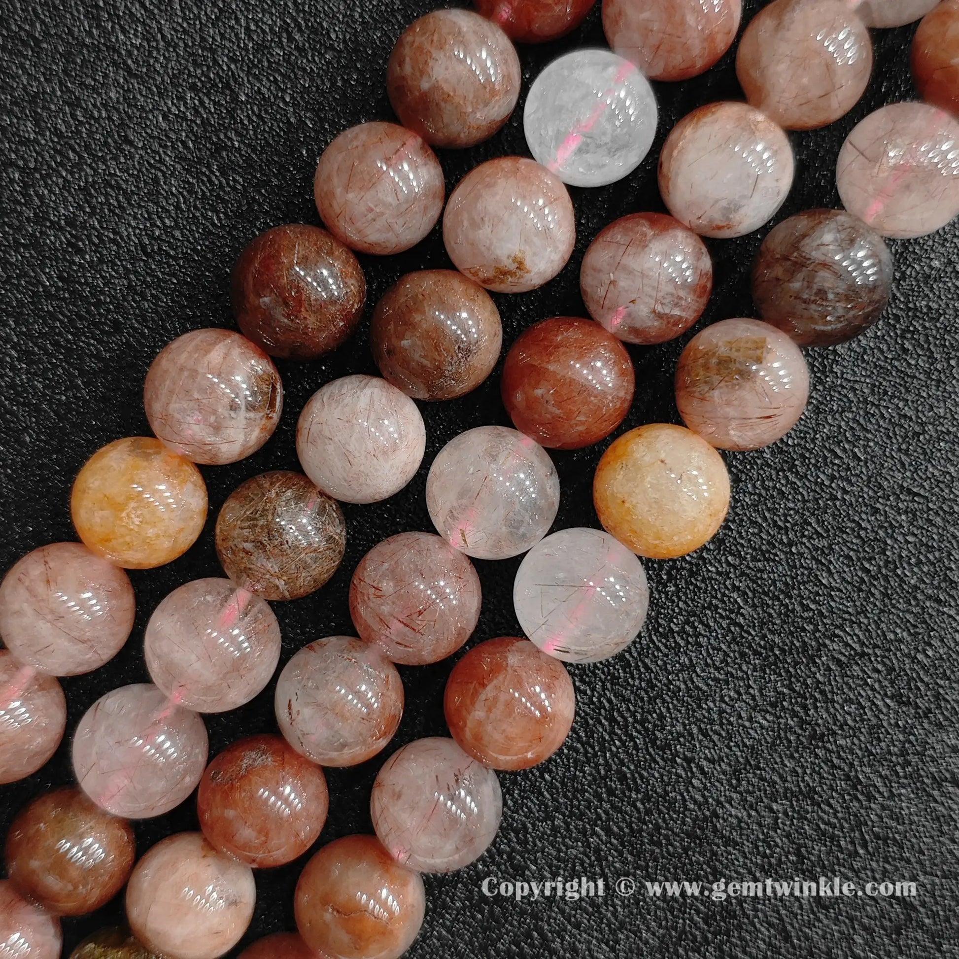 Three strands of un-dyed genuine red rutilated quartz round beads displaying organic iron inclusions and mixed amber tones from factory supplier