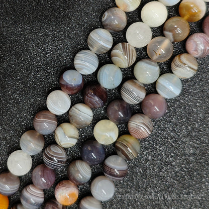 Three strands of raw color persian striped agate loose crystal beads highlighting high polish spherical finish for boutique shop sourcing