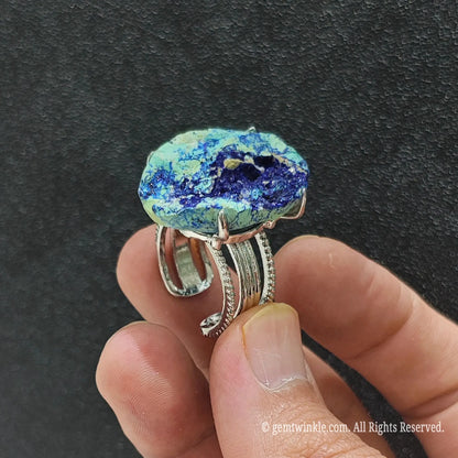 Uncut azurite cluster geode slice ring side view held in hand showing organic stone thickness and textured alloy band