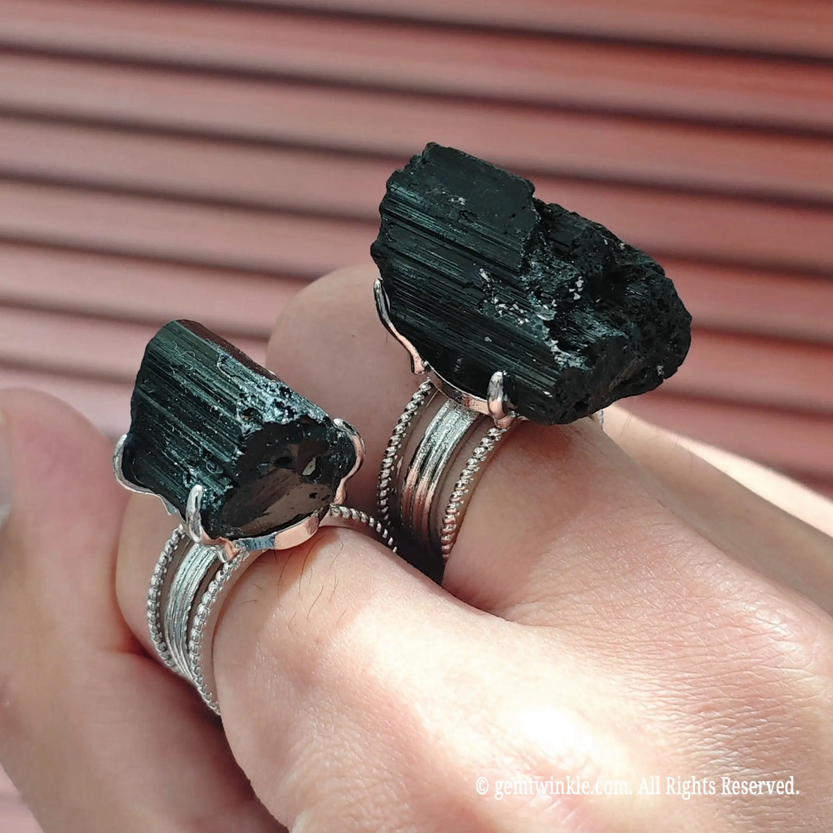 Close up shot of unisex gothic black tourmaline ring resting on hand under studio lighting