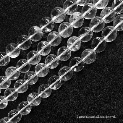 Untreated natural clear quartz loose beads available in sizes 4mm to 12mm with distinct organic inclusions