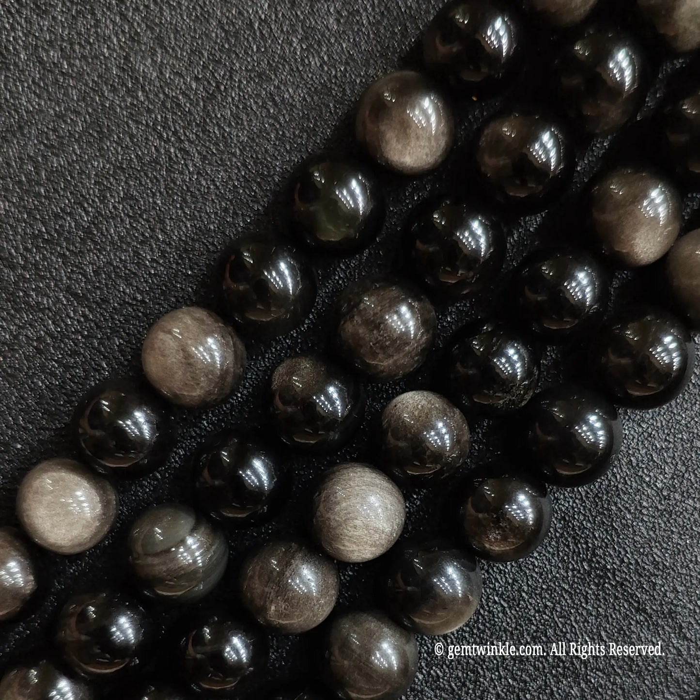 Natural silver flash obsidian crystal beads strands showing bright reflective metallic sheen under light