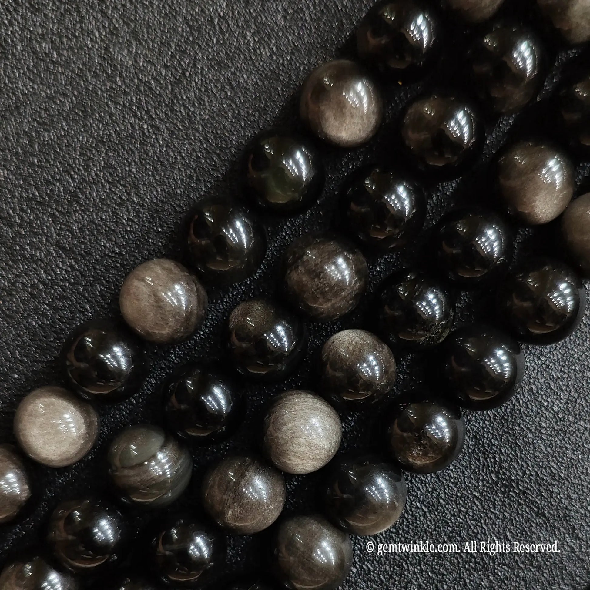Natural silver flash obsidian crystal beads strands showing bright reflective metallic sheen under light