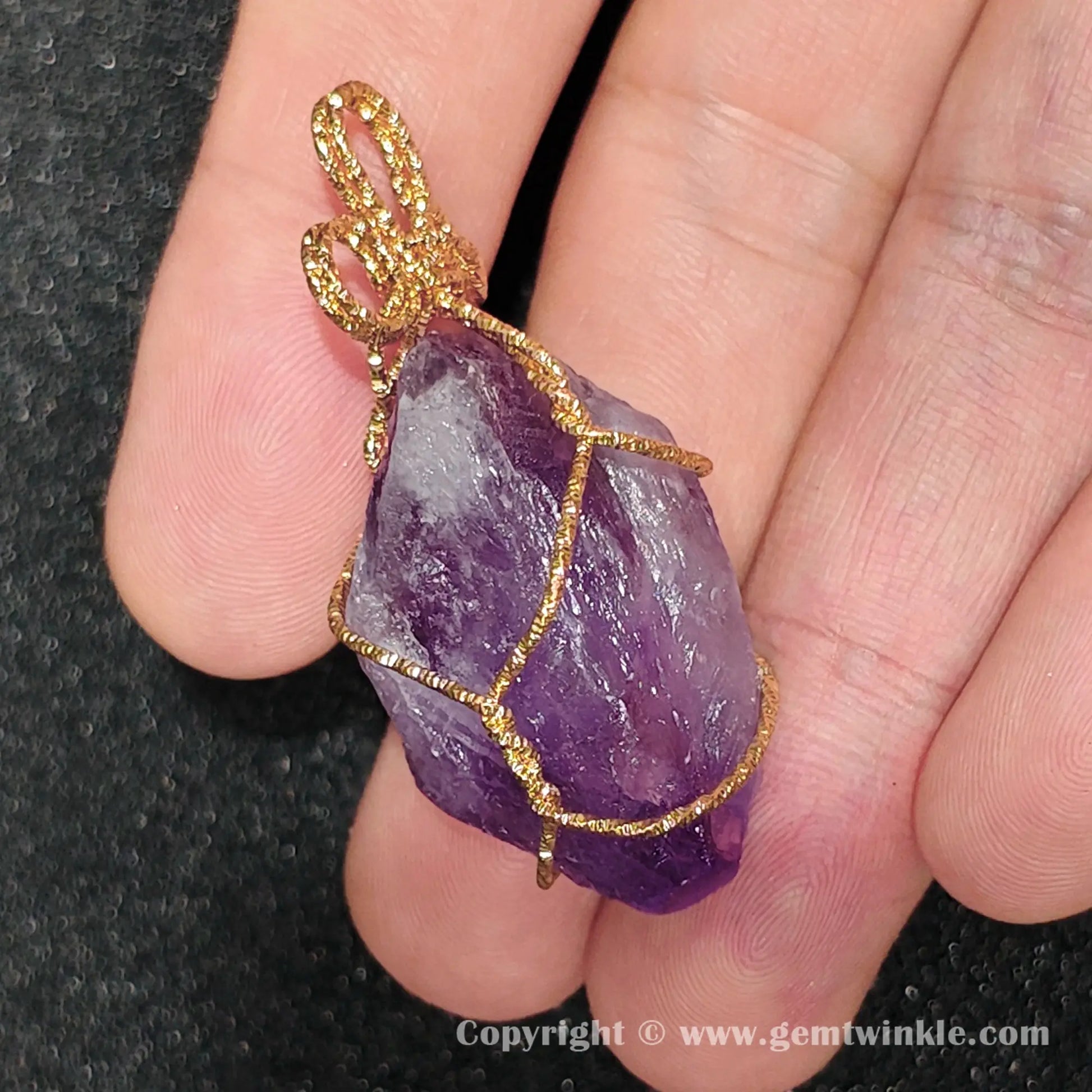 Close up preview of unpolished amethyst rough specimen with internal white clouding and wire frame