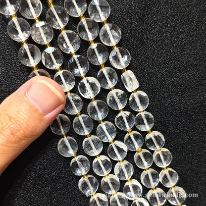 Hand preview showcasing 8mm and 10mm clear rock quartz faceted wheel beads