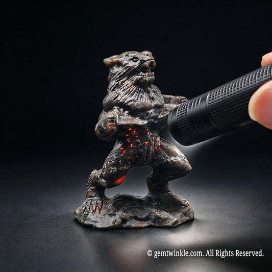 carved werewolf monster statue with chest and legs glowing bright fiery orange sodalite fluorescence under uv torch light