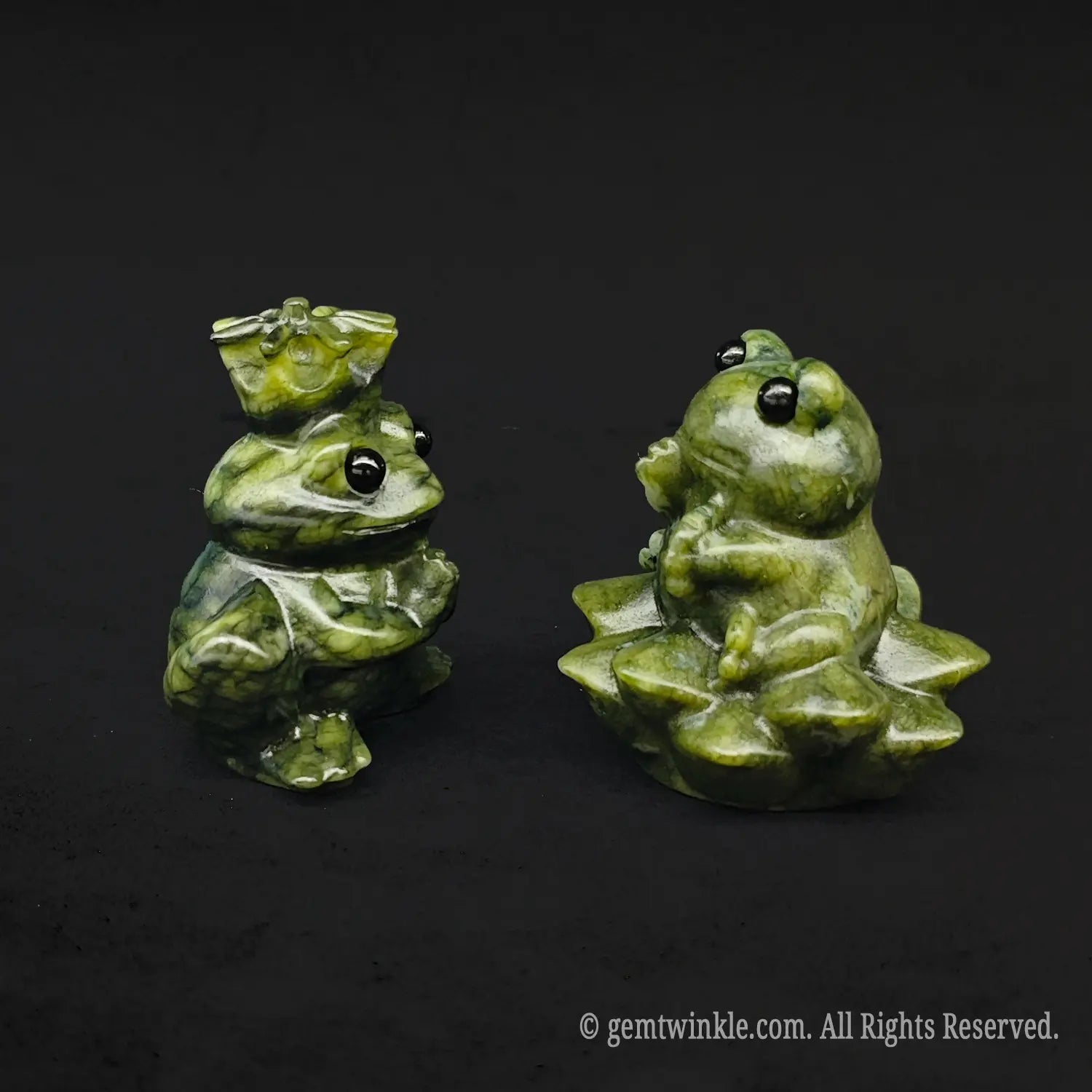 Side view of a whimsical serpentine stone frog royalty couple carving displaying the detailed multi layered lotus base and royal crown