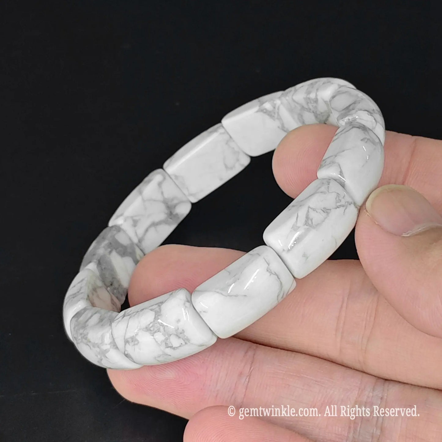 natural white howlite 16mm bar bead stretch bangle bracelet held in hand